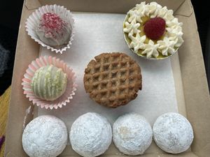 Matcha, hibiscus, and London fog tea cookies. Pandan and raspberry truffles, mango and matcha tartlet. Nutter Butter alternative made in house cookie sandwich.   at Askatu in Seattle