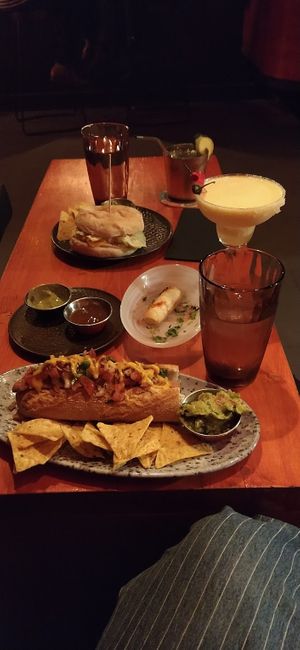 chicken burger, sausage, tequeños, cocktails and tap water at Vyb Bar in Barcelona
