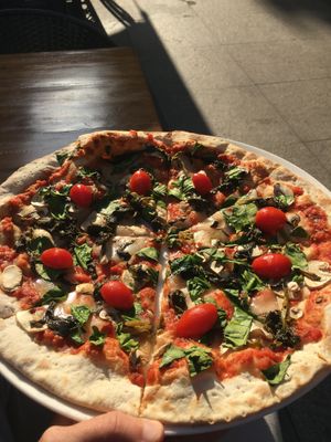 Vegan pizza and outdoor seating at Topolino Pizza in Shanghai