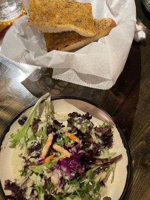 Garlic olive oil bread and salad with tahini dressing that was excellent ! at Nine Mile Montford in Asheville