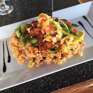 Tonight's special at Nine Mile West: Jerk tofu with grilled brussel sprouts, caramelized onions, currents, and roasted garlic tossed in masaman curry and Israeli couscous, garnished in basil, almonds, and a balsamic drizzle.   at Nine Mile Montford in Asheville