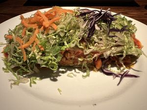 Fiesta enchilada entree- Marinated vegan chicken, romaine lettuce, corn salsa, vegan cheese, spinach tortilla, and homemade enchilada saucee  at Cafe Sunflower in Atlanta