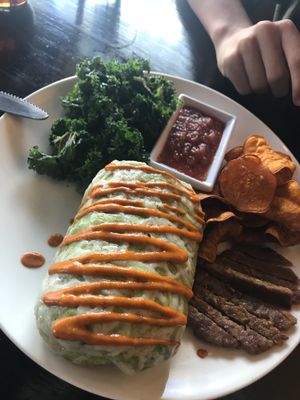 Breakfast burrito with really yummy kale, sausage my son even ate, sweet potato chips and salsa. Mmmm! at Cafe Sunflower in Atlanta