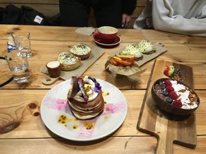 Poached eggs, Alicia’s pancakes and choco protein smoothie bowl  at Frutas Prohibidas in Madrid