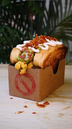 SANDWICH DE REVUELTO Y AGUACATE: Toasted brioche bread, scrambled WEVOs (vegan eggs), smashed avocado, sour cream, and vegan bacon bits. at Frutas Prohibidas in Madrid