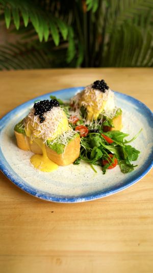 WEVOs BENEDICT TRUFADOS: Two WEVOs (vegan eggs) on sourdough brioche, avocado cream and hummus, hollandaise sauce, Parmesan cheese, and truffle pearls.
 at Frutas Prohibidas in Madrid