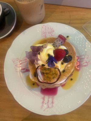 Alice stack pancakes (with passion fruit coulis and violet sugar bark & vegan Chantilly cream) 🤤   at Frutas Prohibidas in Madrid