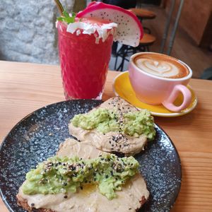 Pitaya smoothie, avocado toast and hummus. Latte at Frutas Prohibidas in Madrid