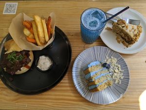 Bbq jackfruit burger with fries, blue spirulina cake and lemonade, carrot cake at Frutas Prohibidas in Madrid