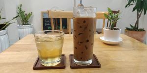 Iced jasmine tea and iced Vietnamese coffee (plant milk options) at Nâunâu in Ho Chi Minh City