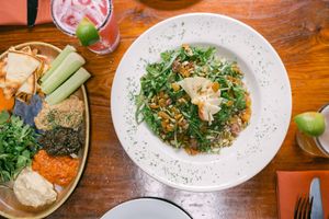 Mezza Platter and Quinoa salad with arugula, apple, golden raisins, sunflower seeds, candied almonds, goat cheese (optional) & a citrus/hibiscus vinaigrette.  VEGAN w/o goat cheese at Fernwood Bar & Grill in Big Sur