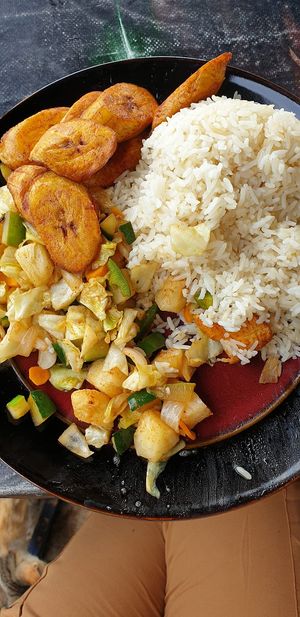 Piri piri vegetables with plain rice and fried plantain at The Rising Phoenix in Accra