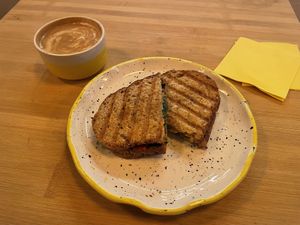 Sandwich vegano y capuccino con leche de sona  at Mia in Malaga