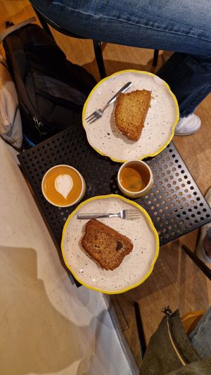 Banana bread and coconut plumcake. Cappuccino with almond milk. at Mia in Malaga