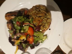Slightly blurry pic of a stuffed butternut squash with potatoes and salad. at The Godstone Inn in Godstone