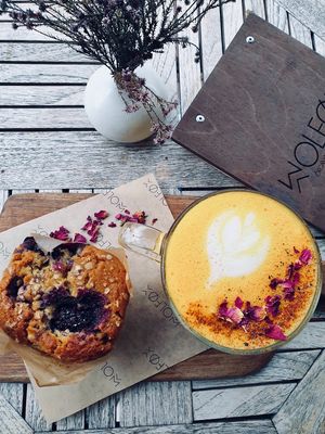 Turmeric latte and berry muffin at Wolfox in Brighton