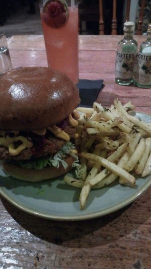 Fried chick'aint bun, rosemary truffle fries and Flora Dora cocktail. at Ninety Nine Bar and Kitchen in Aberdeen