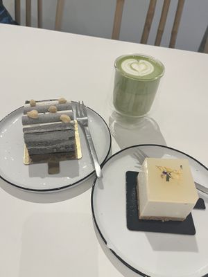 Black sesame cake with frosting, matcha latte and a yuzu cheesecake  at Soi & Co in Berlin