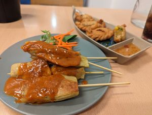 Mock chicken satay, and curry puffs. at Madame K's Vegan- CBD in Melbourne