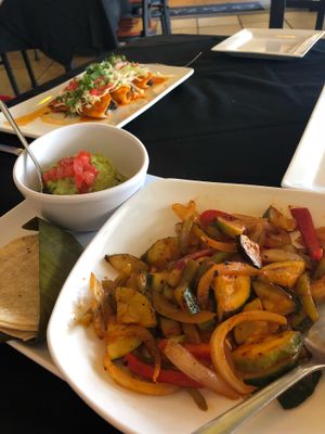 Taquizo Vegetarianos with background vegan enchiladas. at De La Vega in Deland