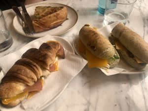 A baguette, a croissant, and a piece of savory pie from the counter  at The Vegan Corner in Barcelona