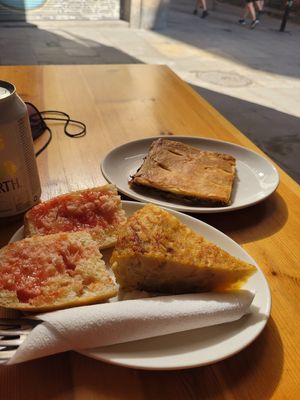 Tomato bread, tortilla de patatas and vegetable empanada. at The Vegan Corner in Barcelona
