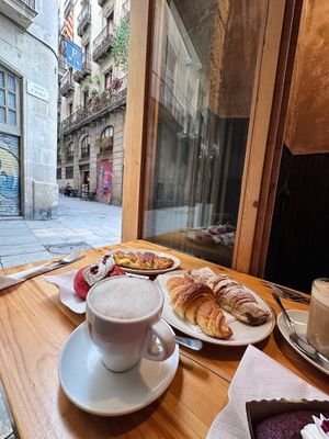 Vegan croissant options (plain, chocolate & vegetable breakfast sandwich), vegan red velvet donut & cake, cappuccino & iced latte with oat milk  at The Vegan Corner in Barcelona