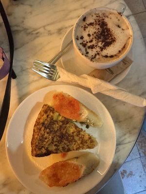 Leek quiche accompanied by some pesto bread (not ordered, but they always add it😄) and a cappuchino  at The Vegan Corner in Barcelona