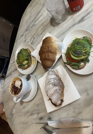 Avocado toast, chocolate croissant, croissant without filling and cappuccino with oat milk.   at The Vegan Corner in Barcelona