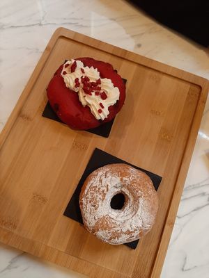 Red velvet Berliner with chocolate and doughnut with chocolate at The Vegan Corner in Barcelona
