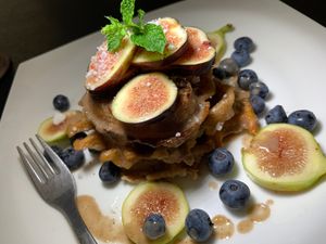 Polenta & Fig Waffles w/ Fresh Green & Black Figs, Blueberries, Cashew Cheeze, Mint, Fennel Sauce at Juice By J in Grand Rapids