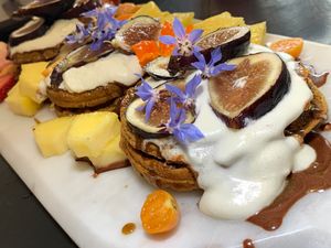 Waffles (Sweet Potato Fennel Walnut):  Pineapple, Gooseberries, Figs, Strawberries, 
Borage Flowers, 
Orange Hibiscus,
Vanilla Sauce, 
Chocolate Sauce at Juice By J in Grand Rapids