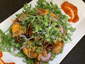 Stuffed "Wacky" Waffle Burger: Almond & Oat Waffle, Garbanzo & Jackfruit Patty, Pine Nuts, Sun-Dried Tomato Sauce, Arugula, Micro Greens at Juice By J in Grand Rapids