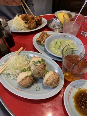 Karaage, gyoza, cucumber with ginger, and drinks  at Izakaya Masaka in Tokyo