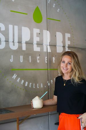 One of our clients enjoying her coconut water at Super Be Juicery in Marbella