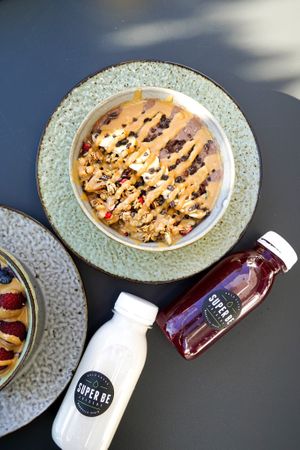 Our smoothie bowls with home-made almond milk, and Beat It (cold-pressed beetroot juice blend) at Super Be Juicery in Marbella