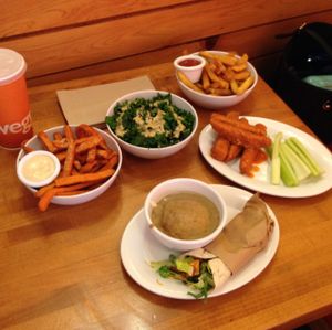 Sweetheart fries, kale salad, buffalo wings, Yukon fries, mini Mexi wrap, and mashed cauli-potatoes at Veggie Grill in West Hollywood