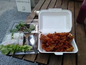 Tofu spring rolls, local herbs, leafy greens and deep fried mushrooms plus a sauce and a juice Recommended.  Takeaway option. at PM Café in Bangkok