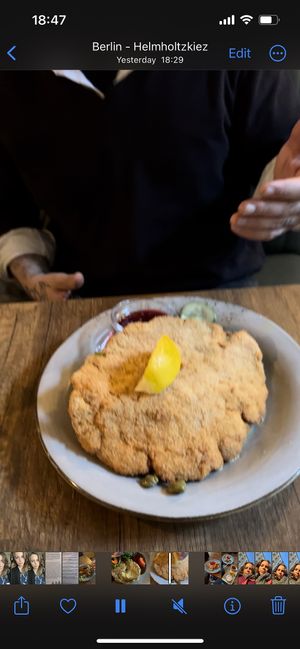 Chicken Schnitzel with potato salad and cucumber salad underneath   at Försters in Berlin