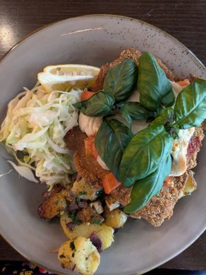Schnitzel with vegan mozzarella, tomatoes, and coleslaw at Försters in Berlin
