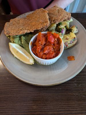Schnitzel with roasted tomatoes and peppers, cucumber salad, and German roast potatoes at Försters in Berlin