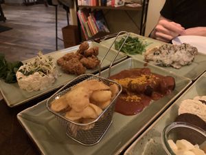 Bread plate in front (hard to see,) schnitzel with potato salad, currywurst and fries, champignons baguette with cheese at Försters in Berlin