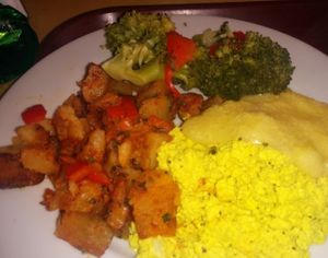 Sunday brunch plate. Seasoned potatoes, broccoli with peppers & onions, cheesy grits, tofu scramble. Broccoli over cooked. Otherwise, quite tasty. at Soul Vegetarian - South in Atlanta