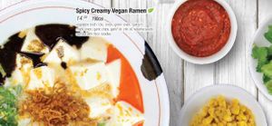 Spicy Creamy Vegan Ramen: vegetable broth: tofu, onion, green onion, spinach, crispy onion, garlic chips, garlic oil, chili oil, sesame seeds served with thick noodles at JINYA Ramen Bar in Santa Monica