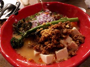 Delicious Flying Vegan Harvest: vegan miso broth: soy meat, tofu, bean sprouts, broccolini,
green onion, corn, red onion, crispy garlic, chili seasoning, served with thick noodles at JINYA Ramen Bar in Santa Monica