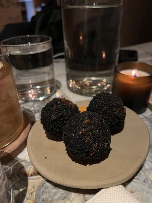 Black rice balls, smoked HOY cheese filling, fermented jalapeno sauce  at MESA Restaurant in Paris