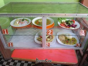 Case in front of restaurant with daily appetizer (top row) and main (bottom row) choices. at Sabor y Vida in Lima