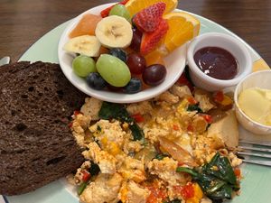 Tofu scramble (I had already eaten some when the photo was taken), hold the mushrooms, with side of fruit and rye toast at Junior's Cafe in Portland
