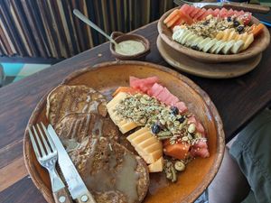 Pancakes (front) and fruit bowl. at Elela in Valladolid