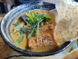 Coconut noodle soup with tofu and mushrooms at TA Vegan House in Hamburg